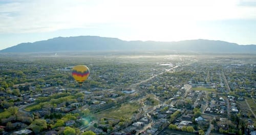 Scenic Aerial of Cityscape with a Hot Air Balloon