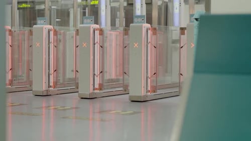 Row of Airport Gates with Red Lights in Building Facade