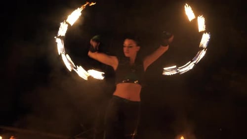 Woman Performing a Mesmerizing Fire Dance at Night