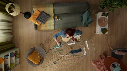 Woman Doing Laundry in Apartment from Above