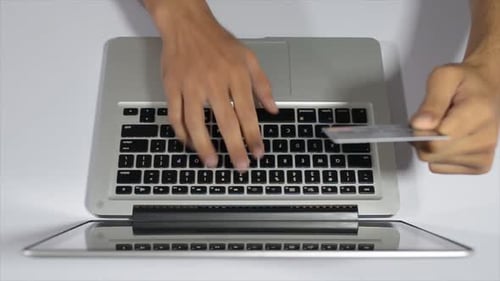 Typing on Laptop with Credit Card in Hand
