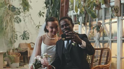 Smiling Bride and Groom Take Wedding Selfie