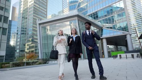 Diverse Business Team Walking and Discussing Work in Financial District