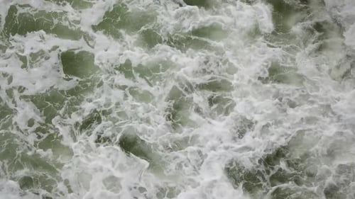 Top Down View Of Dramatic Foamy Sea Waves - aerial drone shot
