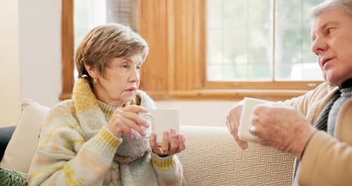 Senior Couple Chatting Together Over Coffee at Home