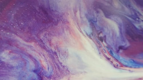 Abstract glittery violet ink explosion background close up shot