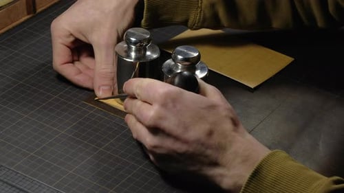 Hands of a Person Who Works with Leather in Workplace