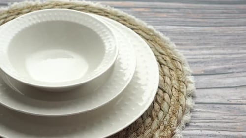 Elegant White Dinnerware on Rattan Placemat