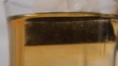 Teabag Slowly Dipping Into Hot Water Macro View