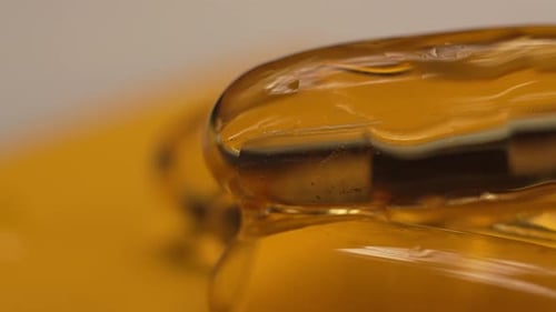 Close-up macro fish oil flows down the gelatin capsules omega 3 fish oil pills