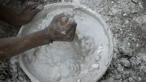 Artisan Mixing White Plaster with Trowel