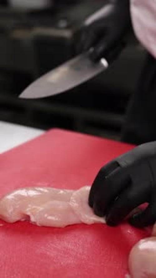 The chef prepares a dish of meat in the kitchen. Close-up