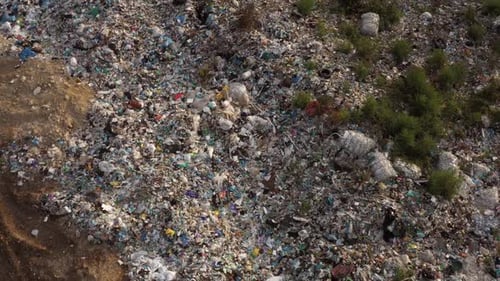 Large Pile of Garbage in a Countryside Field