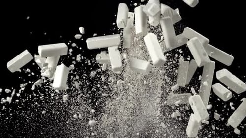 School Chalk Flies Up and Falls Down on a Black Background Filmed on a Highspeed Camera at 1000 Fps
