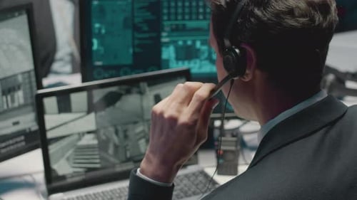 Cybersecurity Officer Watching Multiple CCTV Cameras