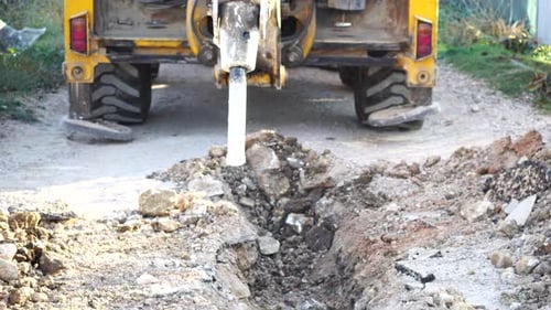 Loud Destruction of Solid Soil Rock with Pneumatic Jackhammer Excavator