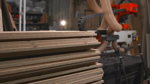 Automated Loader With Robotic Arm And Suction Hose Organizes Plywood Sheets In Busy Workshop Media