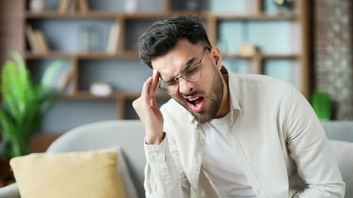Adult Man Massaging Temples in Pain