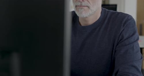 Senior Businessman Working in an Office on Desktop PC