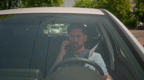 Man Driving and Talking on a Cell Phone