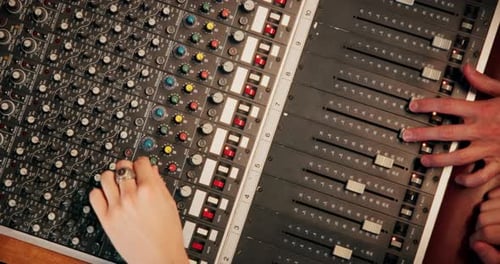 People, hands or audio engineer with sound board for radio production, live streaming or management
