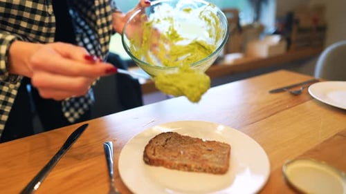 Woman Prepares Avocado Toast at Home
