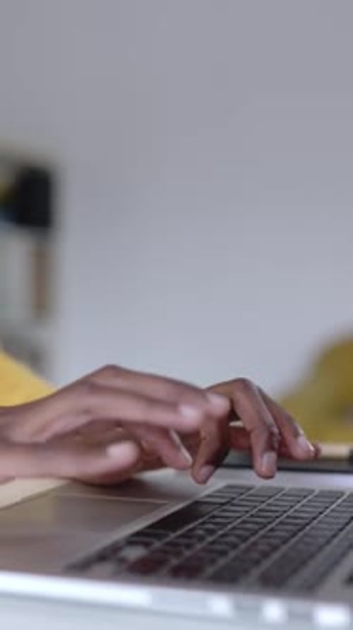 Close Up View of African Woman Hands Working on Laptop Computer From Home