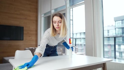 Woman Cleaning White Table in Apartment