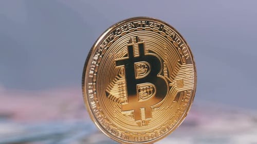 Gold Bitcoin Spins on Edge Close Up