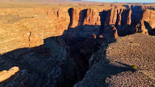 Footage over the edge of the canyon with steep cliffs. View on the river at the bottom