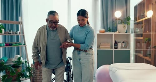 Caring Woman Helping Senior Man Walk