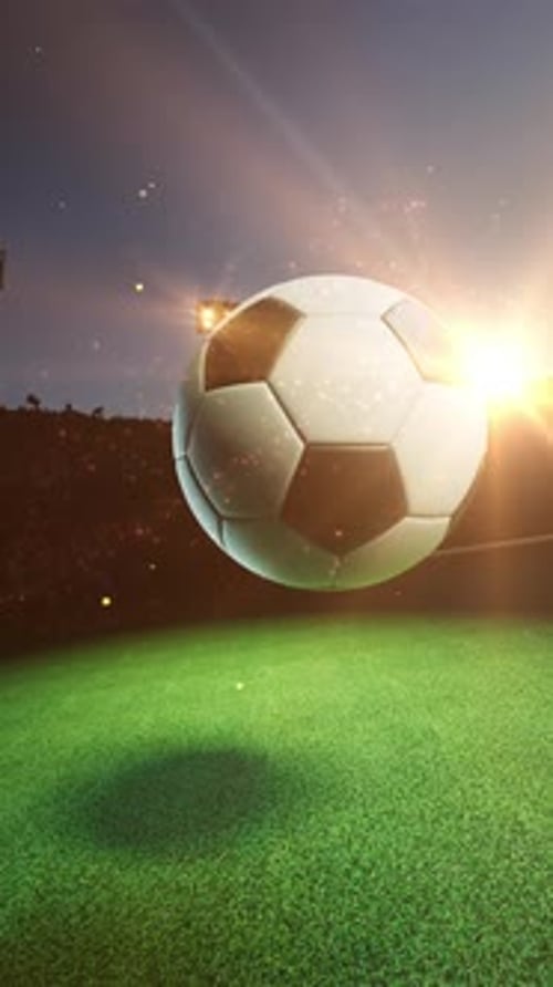 Soccer ball spinning under bright stadium lights.