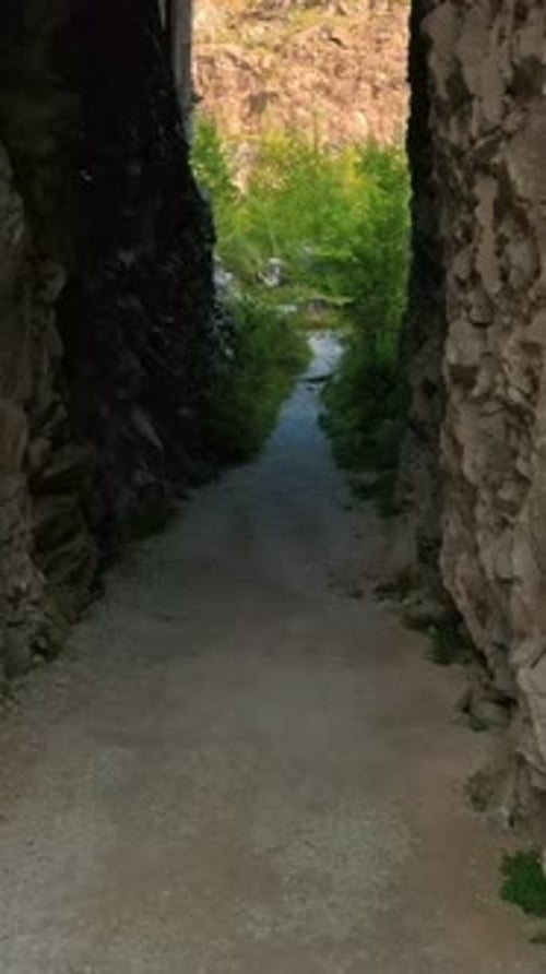 Drone Fly Through Rockcut Entrance of Abandoned Marble Quarry in Carrara Italy