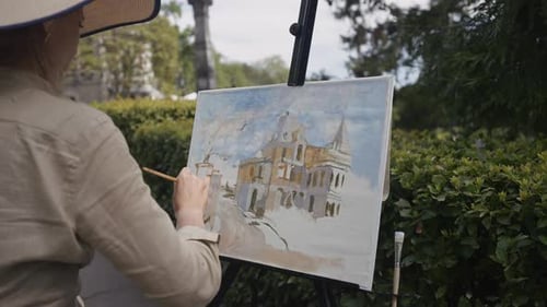 A Female Artist ActionA Beautiful View of the Canvas with a Wonderful Picture of Architecturewhich a