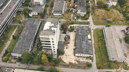 Aerial view of industrial destroyed city buildings. View from above of ruined and abandoned factory.