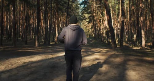 Young Man Running in Forest Marathon Training Spring Outdoor Training on Sunrise Fit Athete Sport