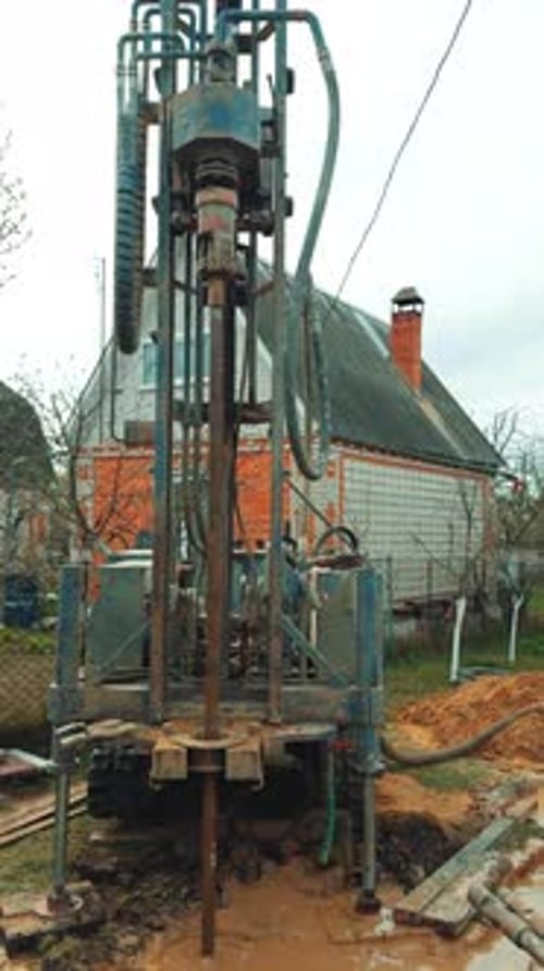 Boring the well with the help of special machinery. Drilling equipment producing the water bore.