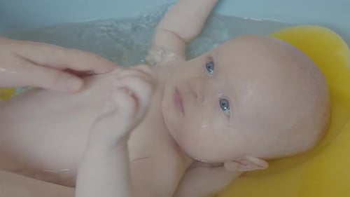 Two Month Old Baby Boy Sweeming In Bath 3