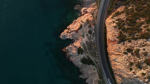 Vertical View of the Winding Road on the Mediterranean Coast the Drone Slowly Rises Up Aerial View