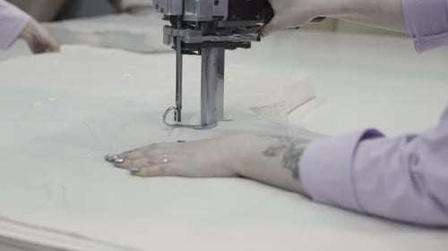 Craftsman Operating Industrial Fabric Cutting Machine for Precise Pattern Cutting