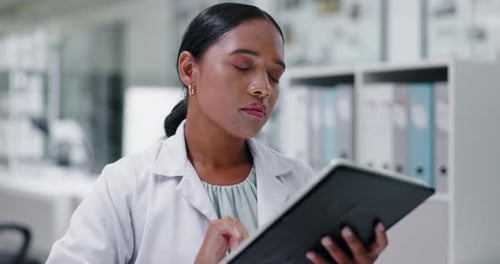 Woman Using Tablet Device in Modern Laboratory