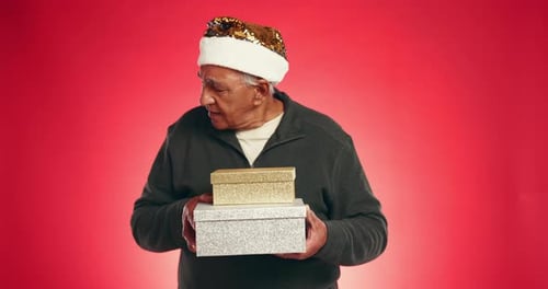 Christmas, box and shake with face of old man in studio for mockup, holiday season and laughing