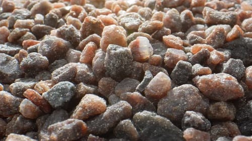 Piles of Coarse Crystalline Black Salt Close-Up