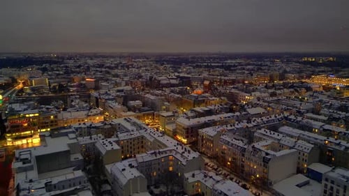 Berlin City lights, rooftops covering in snow winter at dusk. Spectacular aerial view drone
