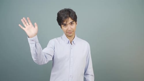 Happy man waving at camera.