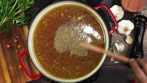 Seasoning Delicious Broth in Red Cooking Pot