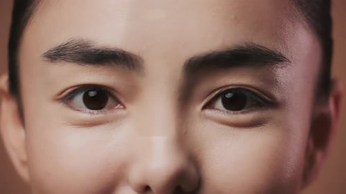 Closeup Of Young Asian Female Looking At Camera Posing Over Studio Background Cropped Beauty