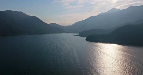 Aerial tracking shot over hazy lake Kawaguchi, sunny, summer day in Japan