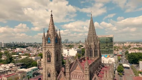 Gothic Spires Reaching Toward a Bright and Cloudy City Sky