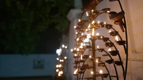 Rows of Oil Lamps Illuminate Buddhist Temple at Vesak Traditional Lights Reflect Spirituality Peace